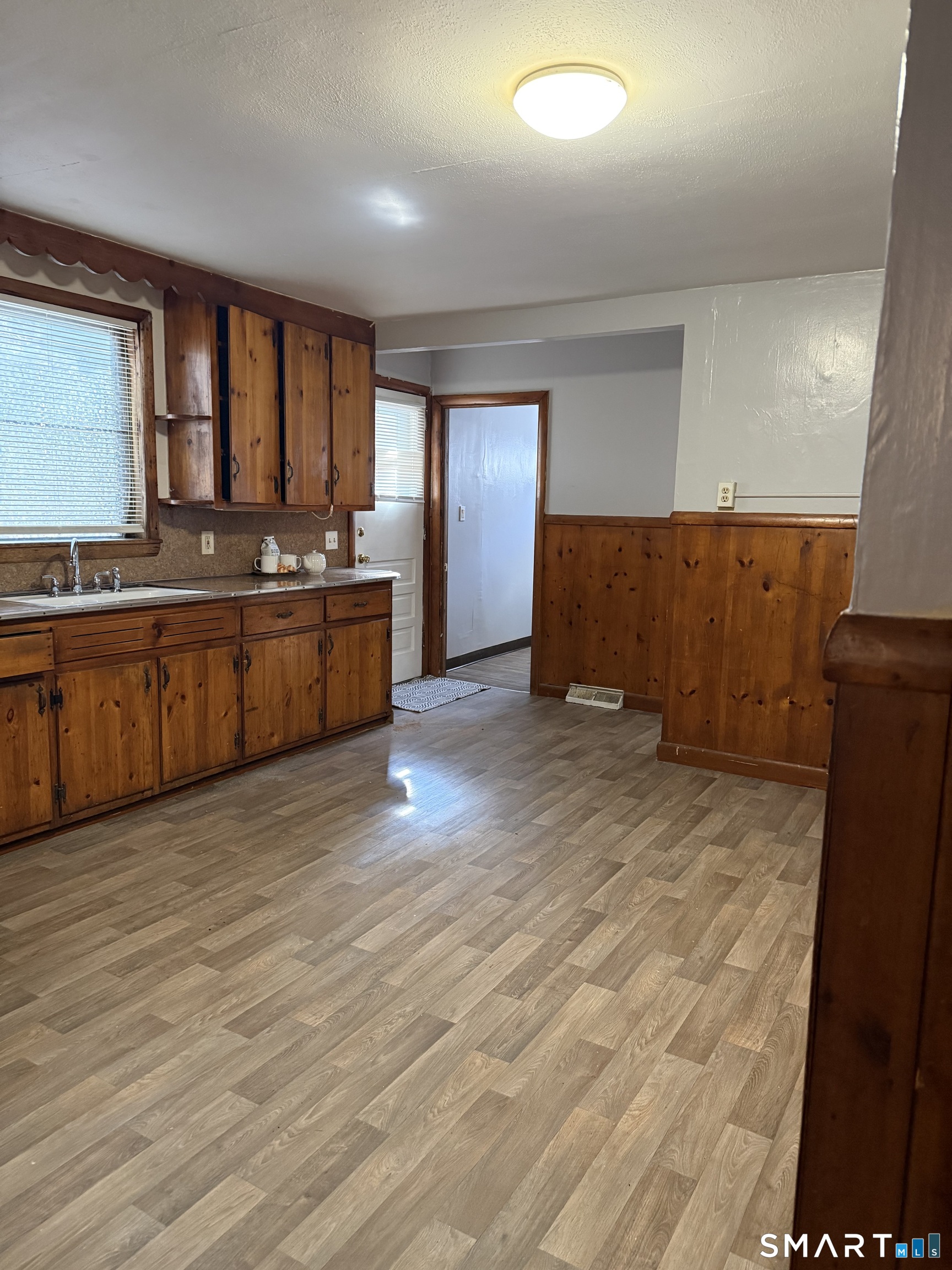 8 Rogers Place Manchester, CT 06040 - Photo 6 of 16 a large kitchen with kitchen island granite countertop a large counter top space a sink stainless steel appliances and cabinets