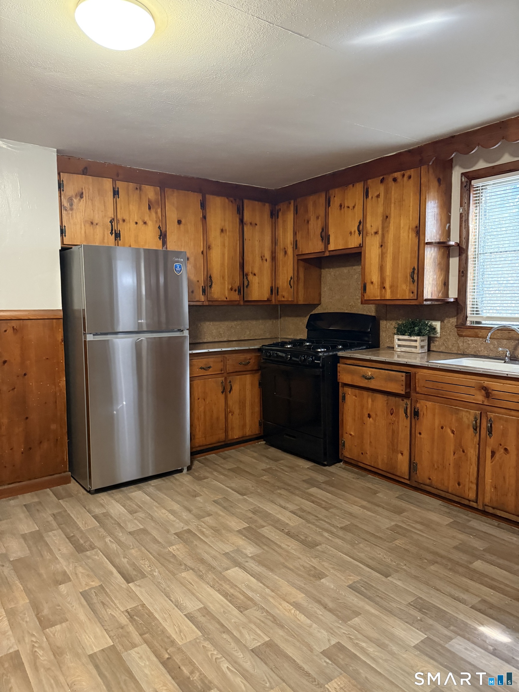 8 Rogers Place Manchester, CT 06040 - Photo 7 of 16 a kitchen with stainless steel appliances granite countertop a stove a refrigerator a sink and a microwave