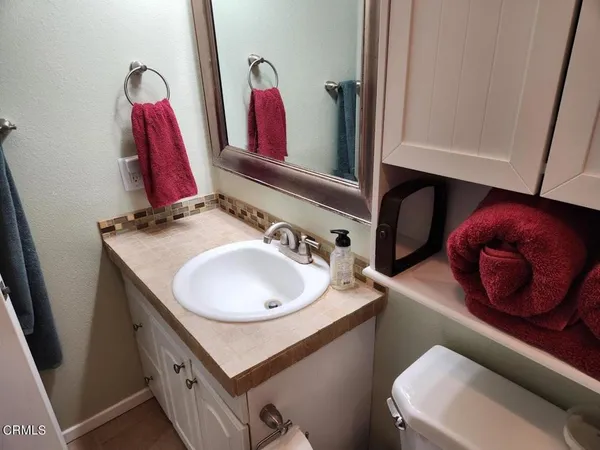 a bathroom with a sink vanity and a mirror