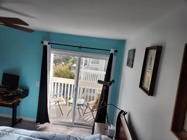 a view of a livingroom with furniture and a window
