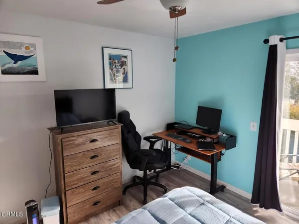 a view of a workspace with furniture and a window