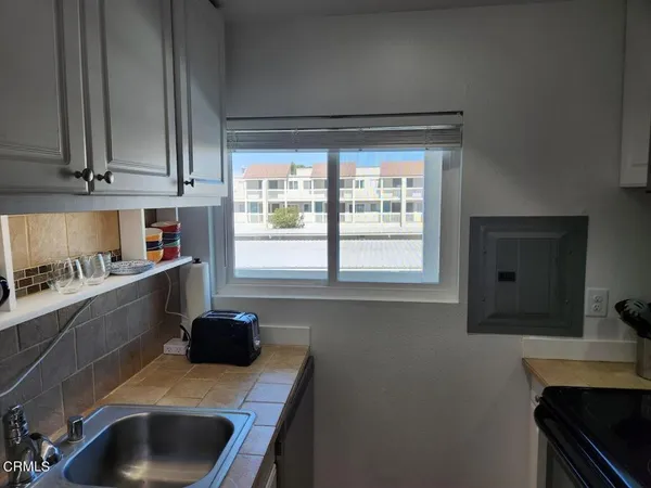 a kitchen with a sink cabinets and a window