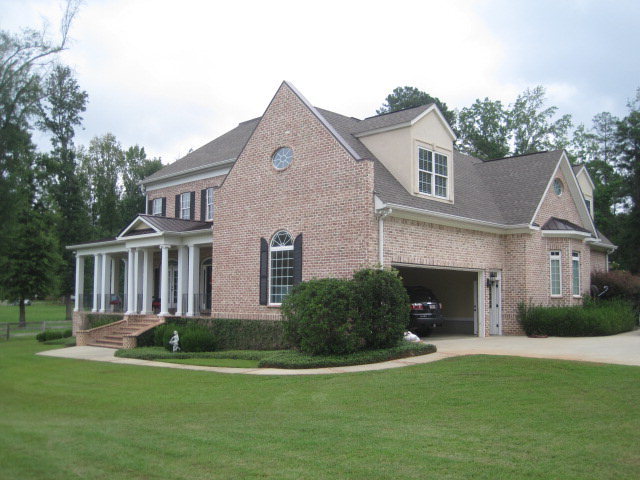 9185 Estes Road Macon, GA 31220 - Photo 2 of 20 a front view of a house with a garden and yard
