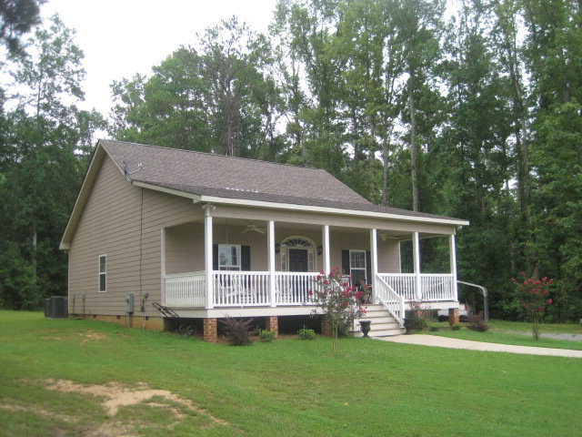 9185 Estes Road Macon, GA 31220 - Photo 20 of 20 a view of a house with a yard deck and a large tree