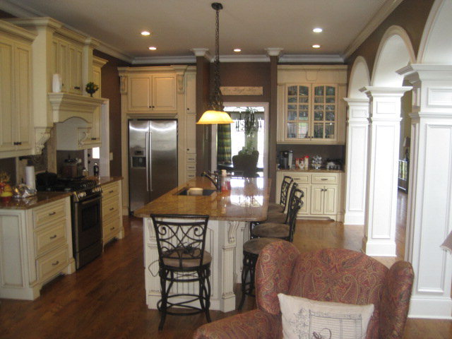 9185 Estes Road Macon, GA 31220 - Photo 5 of 20 a kitchen with stainless steel appliances kitchen island granite countertop a refrigerator a stove and a wooden cabinets with wooden floor