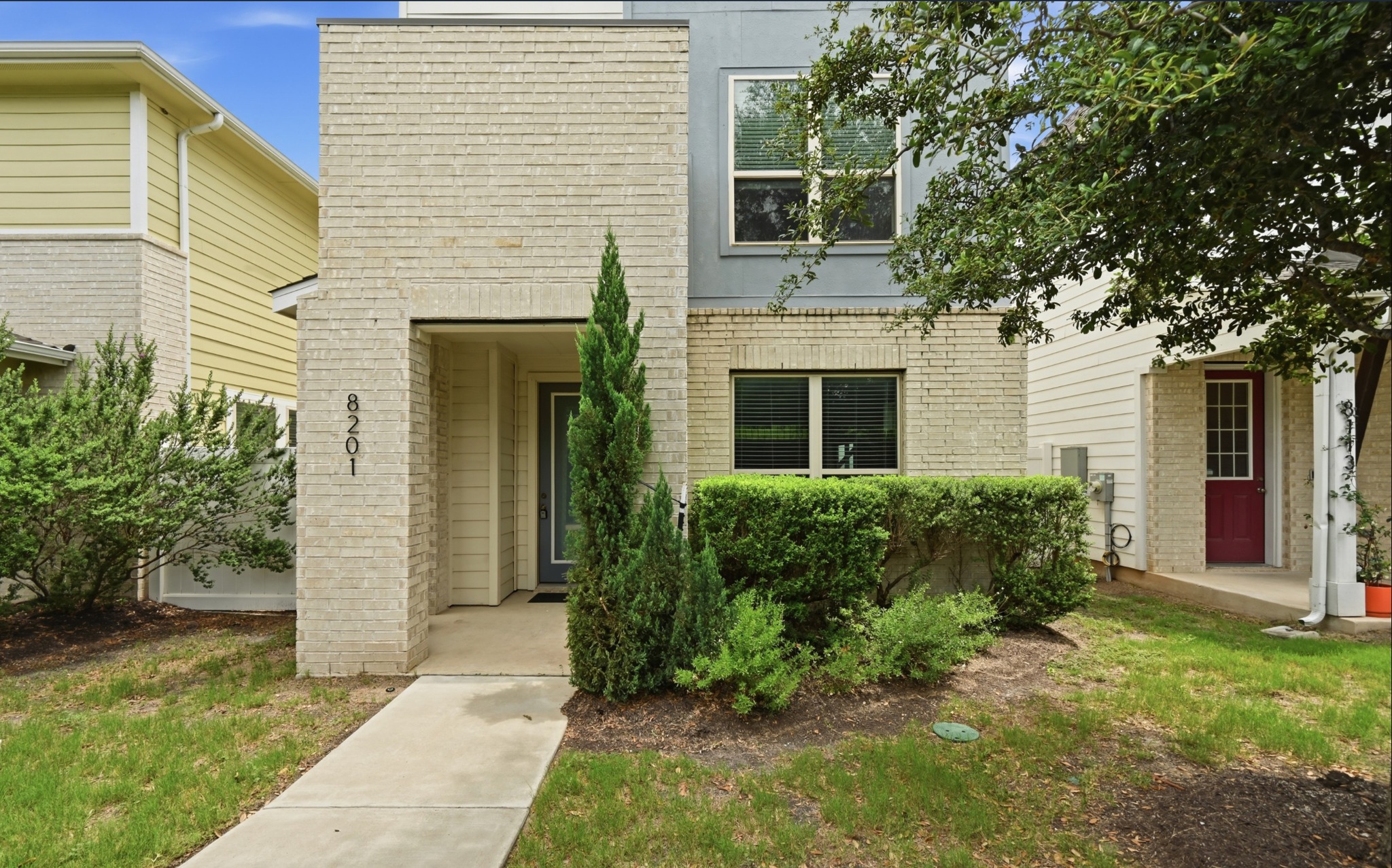 8201 Frida Bend Austin, TX 78744 - Photo 5 of 29 A well-maintained facade showcasing a modern townhome with inviting landscaping.