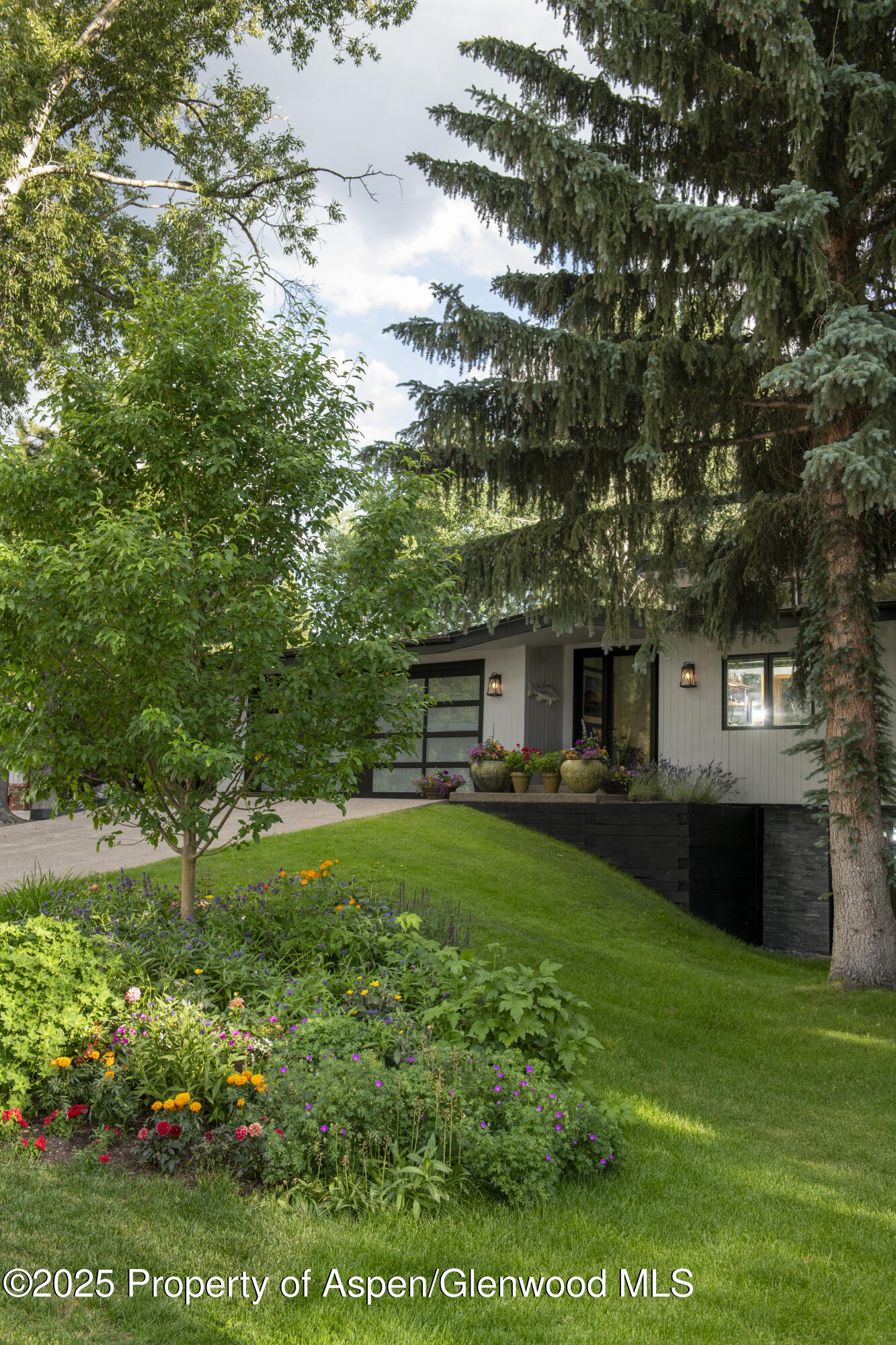 1325 Mountain View Drive Aspen, CO 81611 - Photo 21 of 26 a front view of a house with a garden