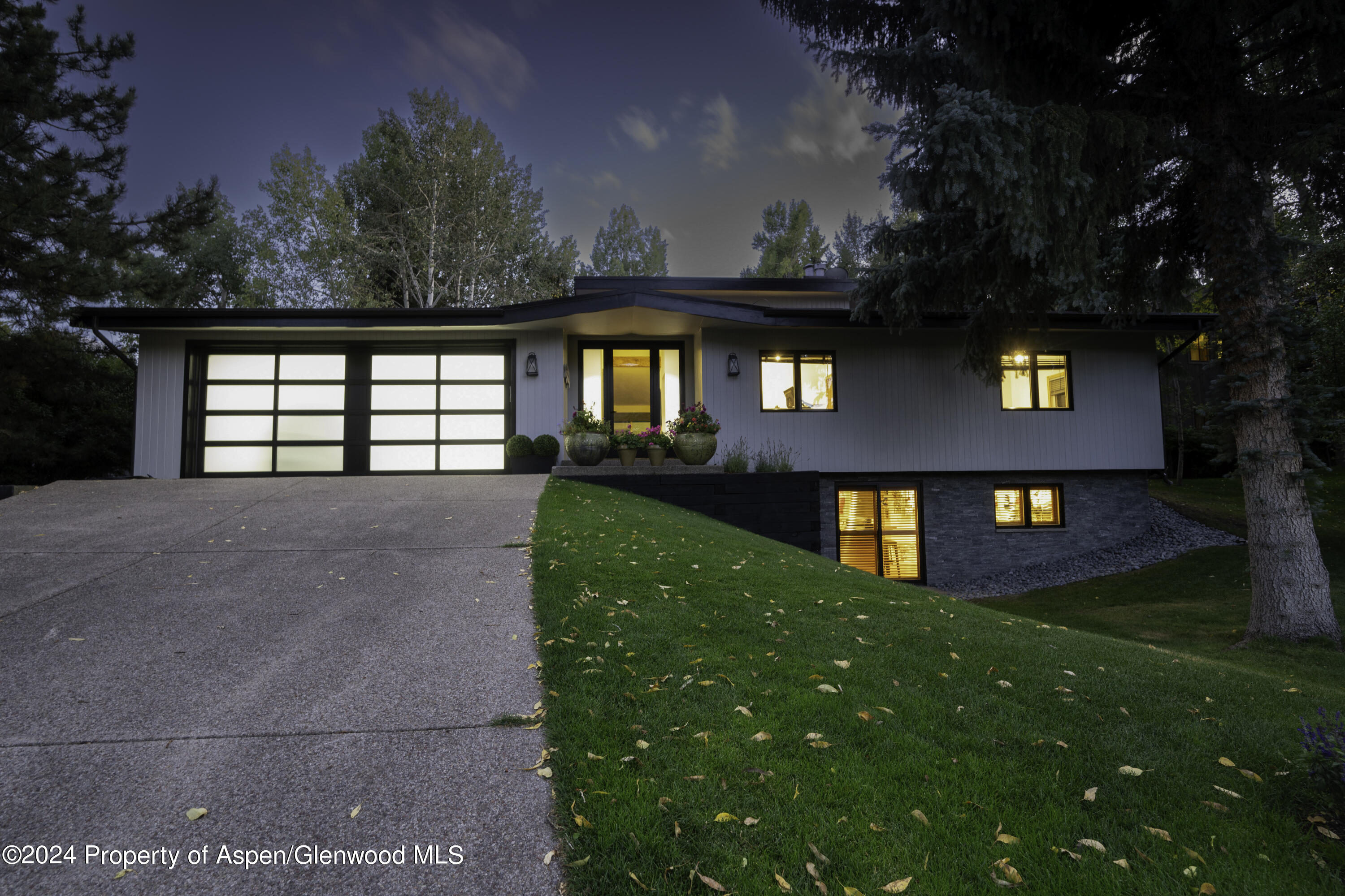 1325 Mountain View Drive Aspen, CO 81611 - Photo 22 of 26 a front view of a house with a yard and garage