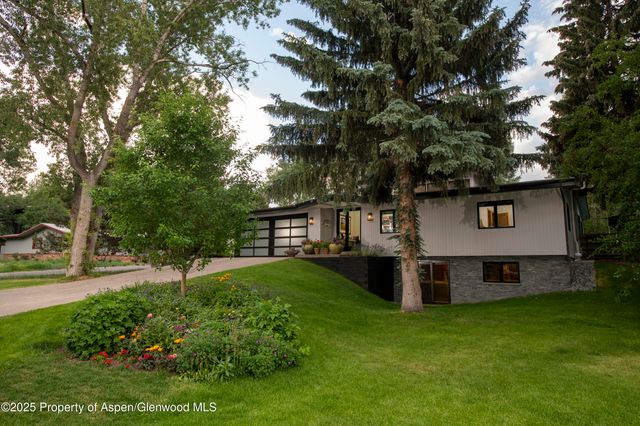 a view of a house with a yard and sitting area