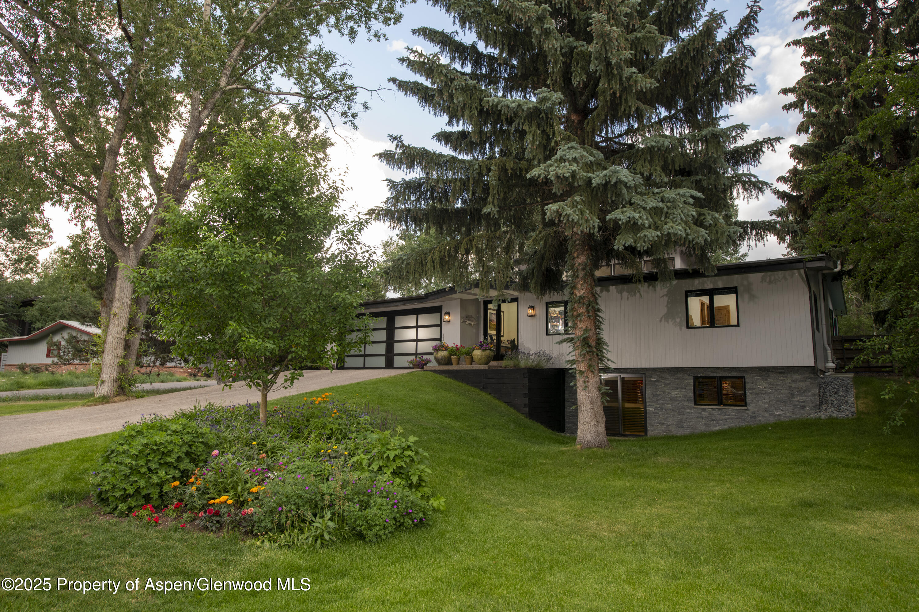 1325 Mountain View Drive Aspen, CO 81611 - Photo 25 of 26 a view of a house with a yard and sitting area