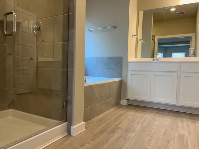 a bathroom with a bathtub and a shower
