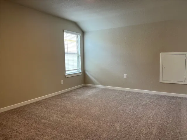 an empty room with windows and closet