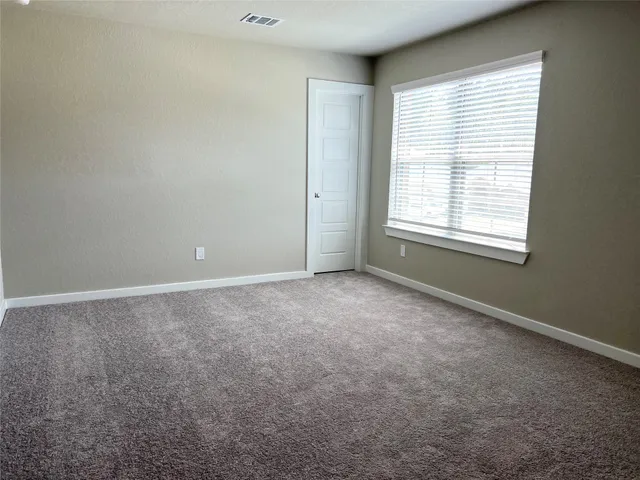 an empty room with a empty space and windows