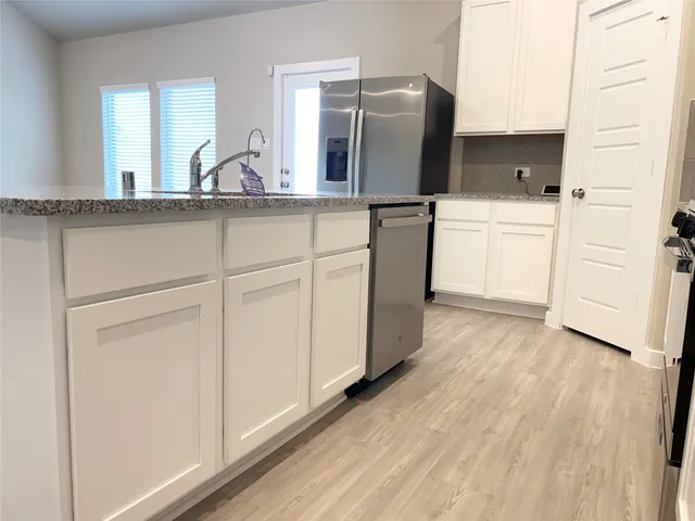 a kitchen with a refrigerator and a sink