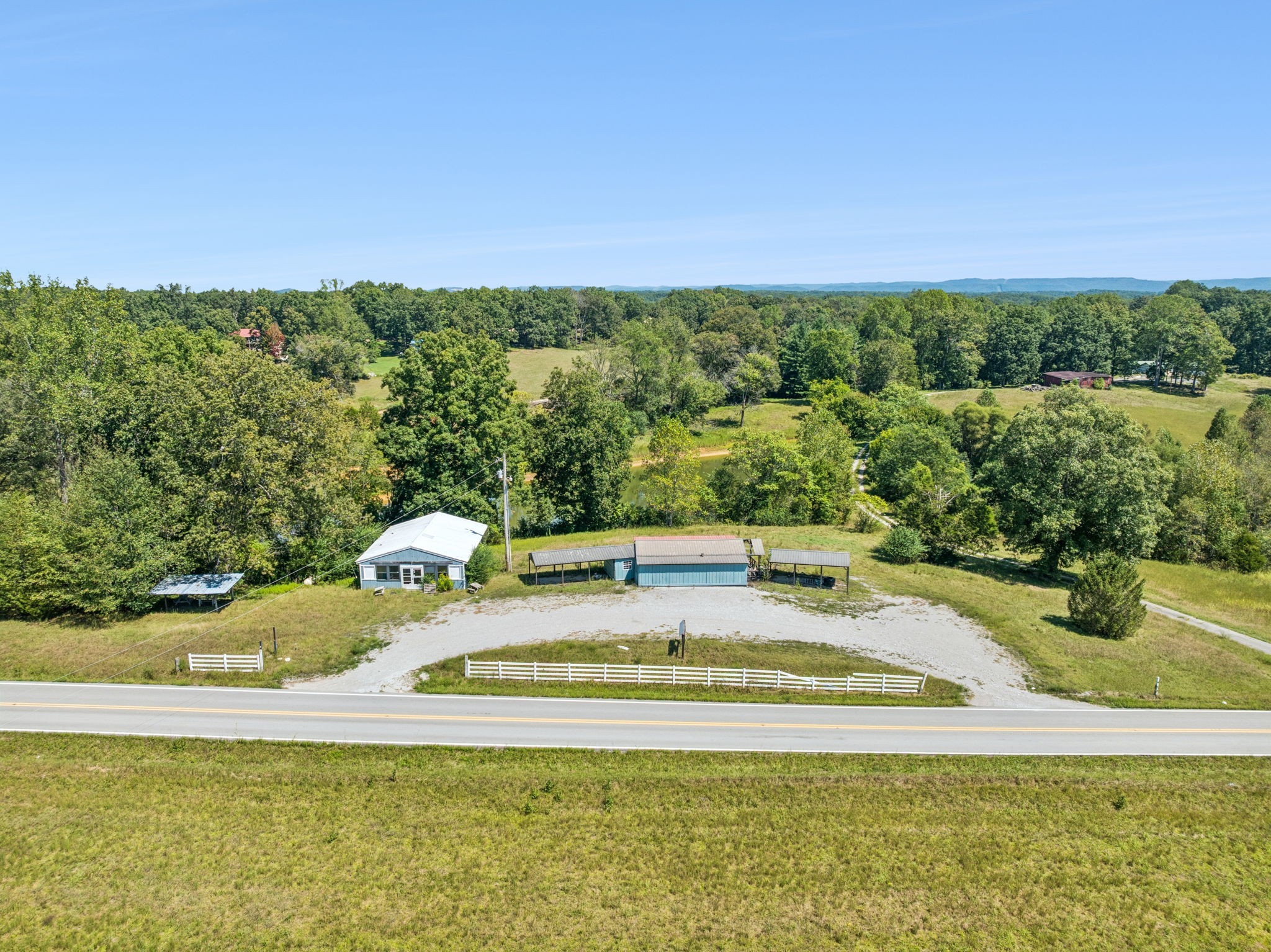 8272 Burgess Falls Road Baxter, TN 38544 - Photo 5 of 41 a view of a swimming pool with an outdoor seating and yard
