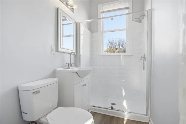 a bathroom with a toilet a sink and a shower