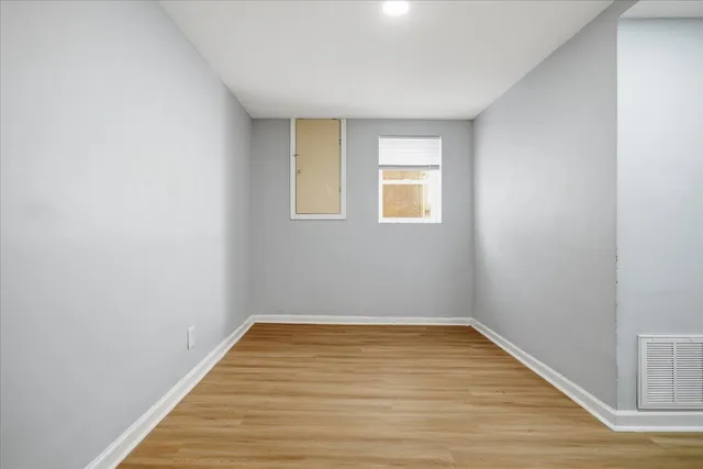 a view of a room with wooden floor and window