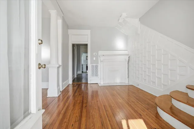a view of a room with wooden floor and a bathroom