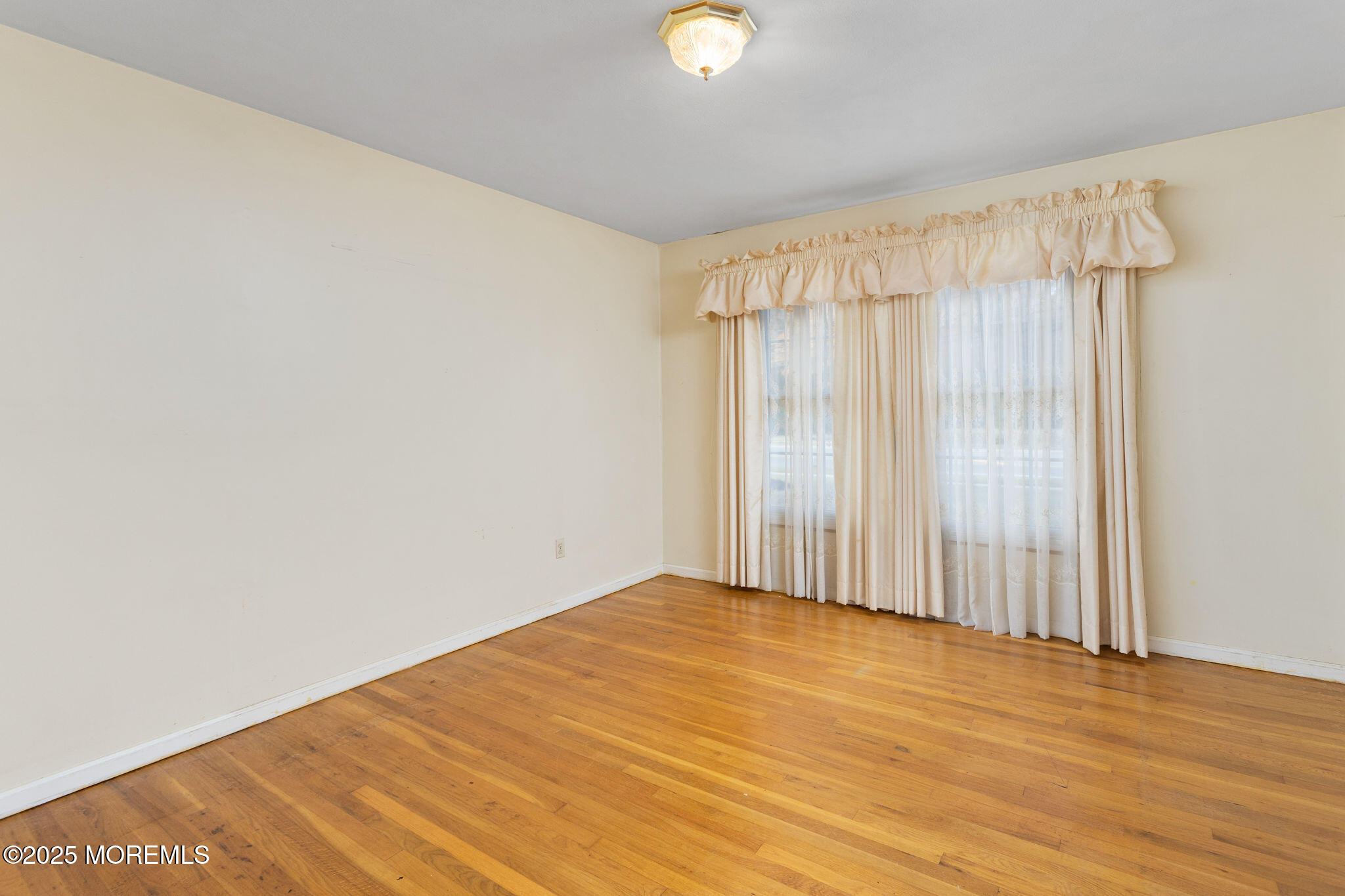 1 Hawk Drive Princeton Junction, NJ 08550 - Photo 9 of 46 a view of an empty room with wooden floor and a window