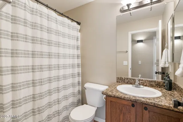 a kitchen with stainless steel appliances granite countertop a refrigerator a stove a sink and a microwave