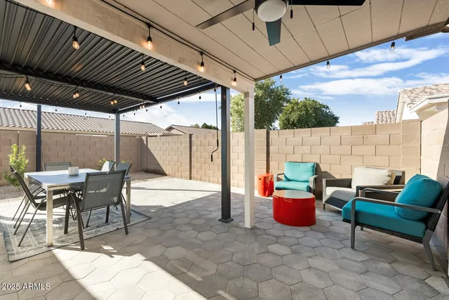 a view of a house with swimming pool and sitting area
