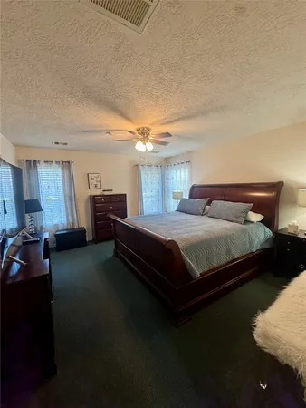 a bedroom with a bed and dresser