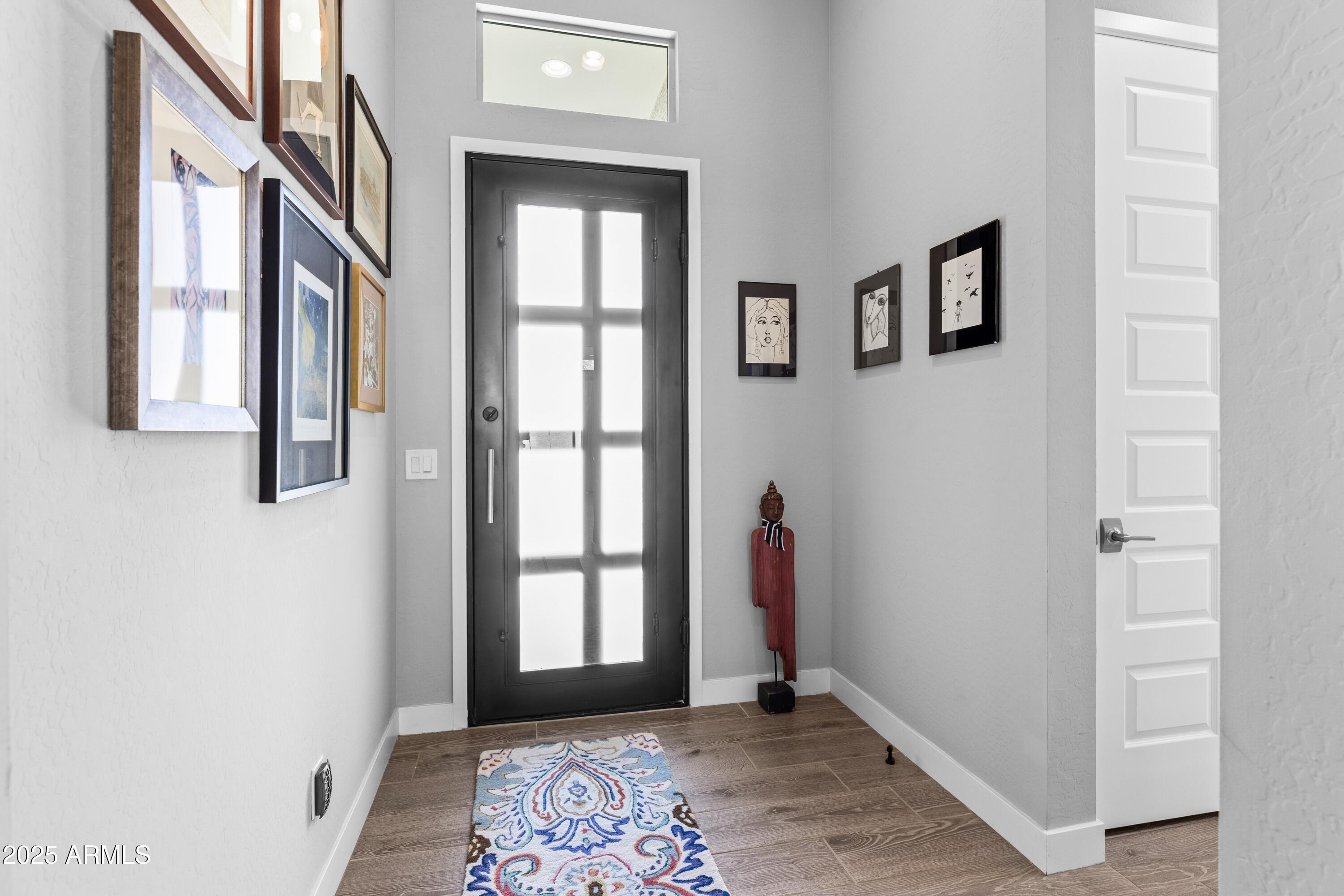 18788 East Blue Sky Drive Rio Verde, AZ 85263 - Photo 12 of 80 a view of an entryway with wooden floor