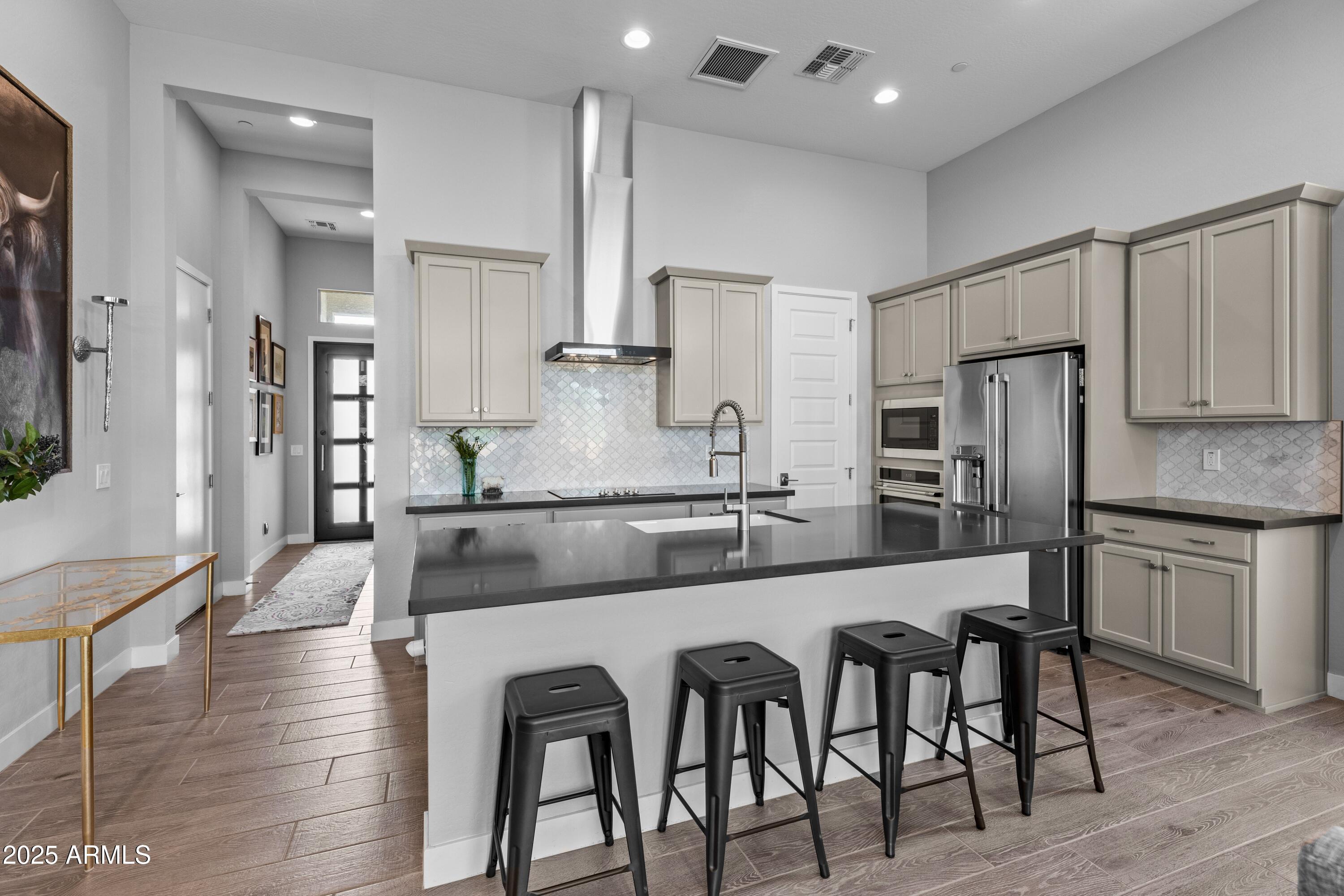 18788 East Blue Sky Drive Rio Verde, AZ 85263 - Photo 15 of 80 a kitchen with stainless steel appliances granite countertop a table chairs stove refrigerator and cabinets