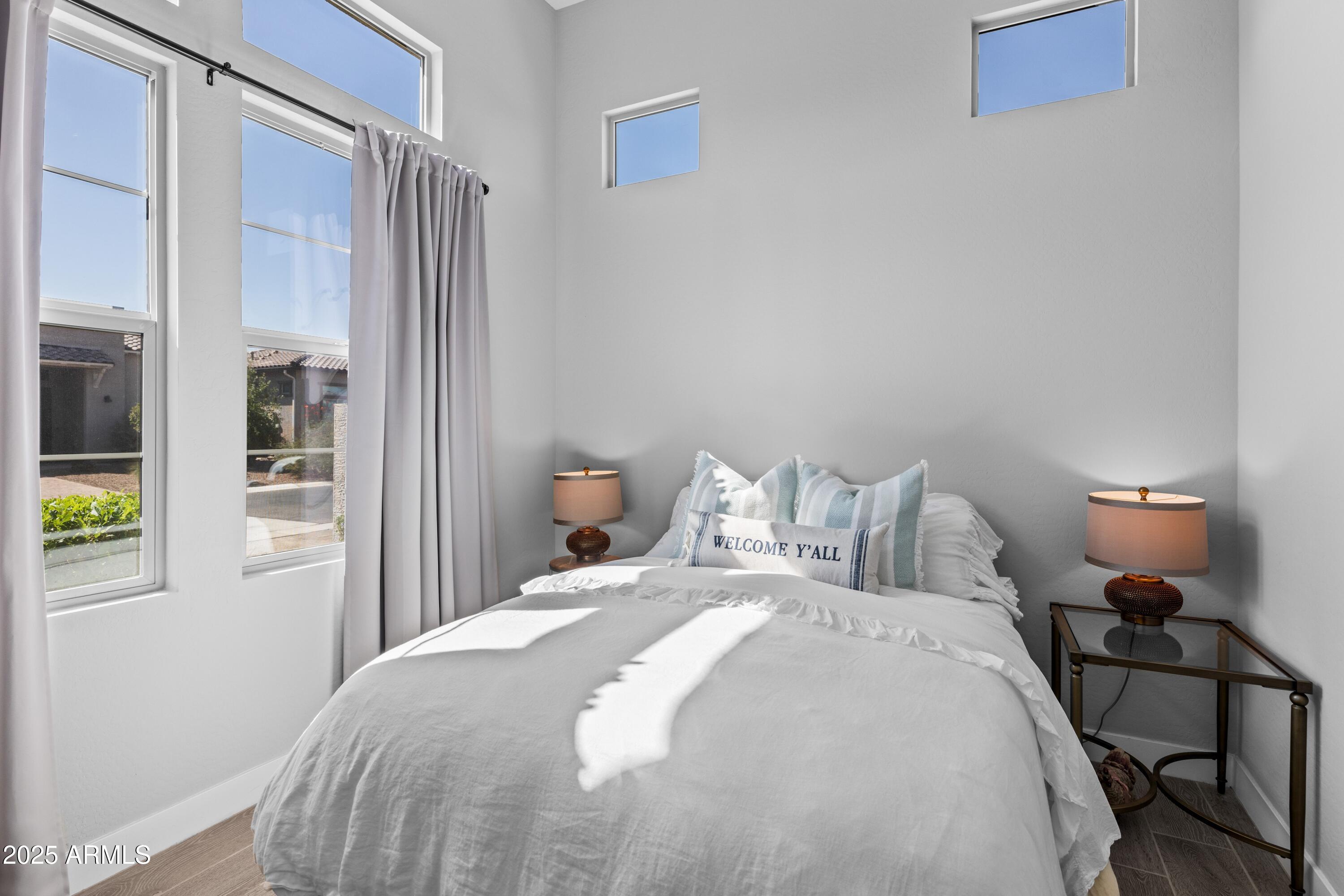 18788 East Blue Sky Drive Rio Verde, AZ 85263 - Photo 27 of 80 a bedroom with a bed and a lamp next to a window