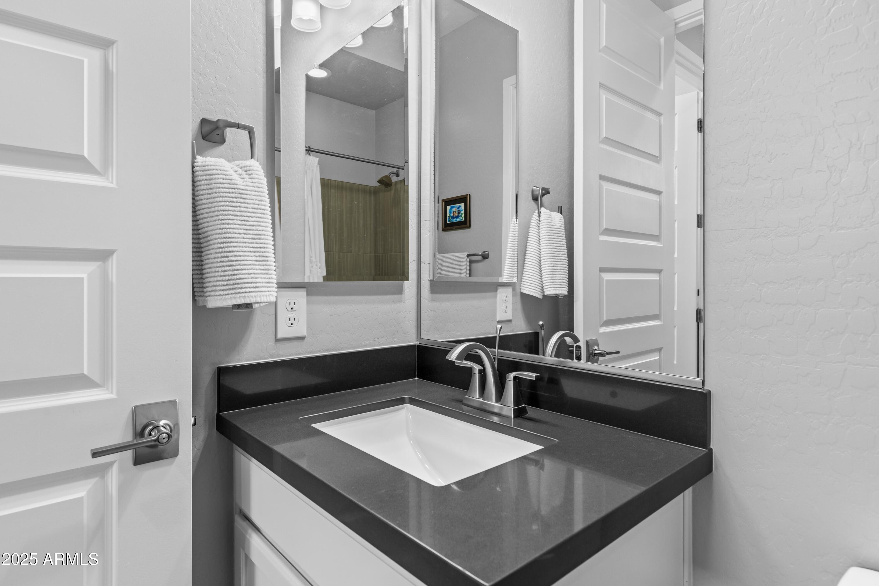 18788 East Blue Sky Drive Rio Verde, AZ 85263 - Photo 31 of 80 a bathroom with a sink and a mirror