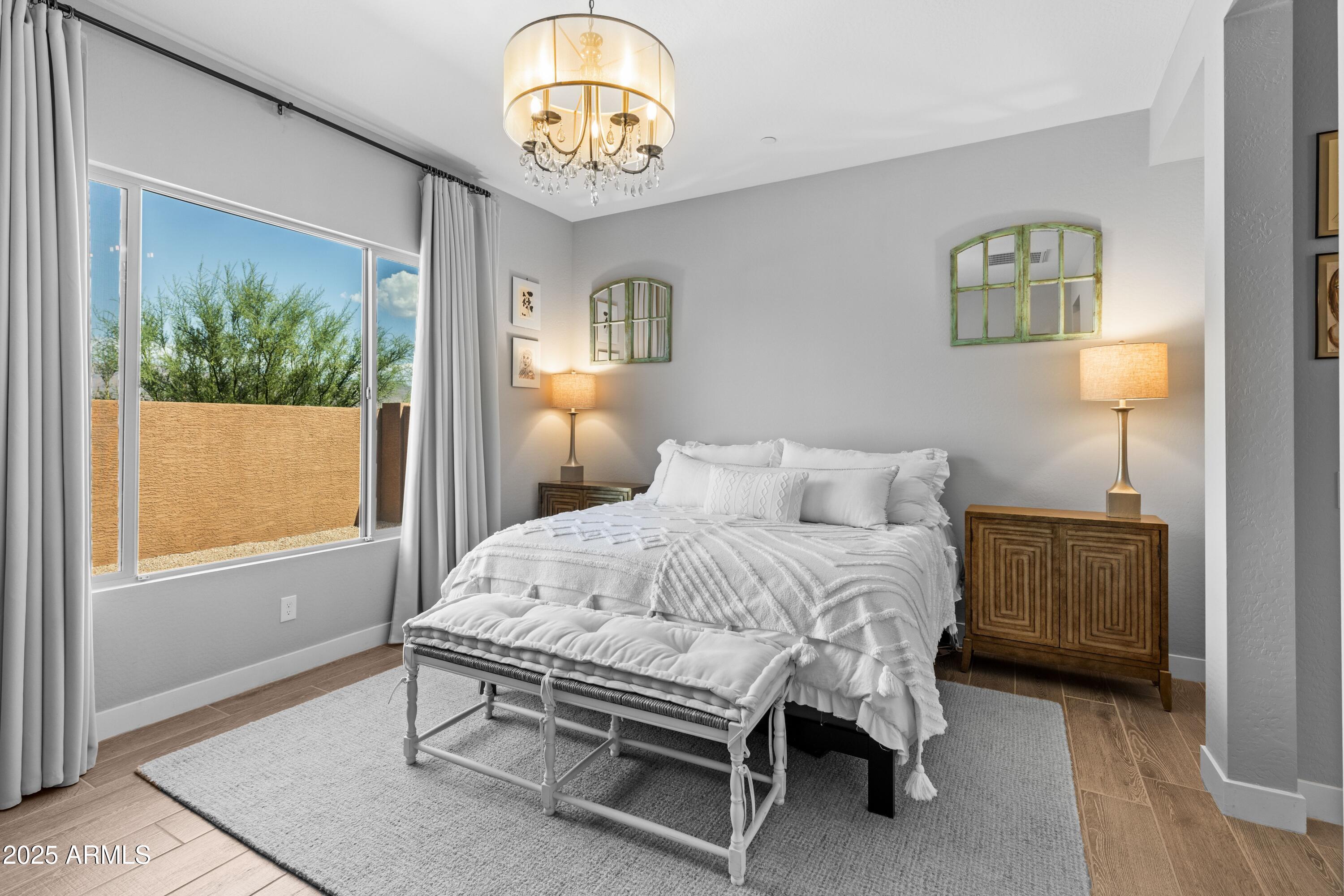 18788 East Blue Sky Drive Rio Verde, AZ 85263 - Photo 4 of 80 a bedroom with a bed and a table in it