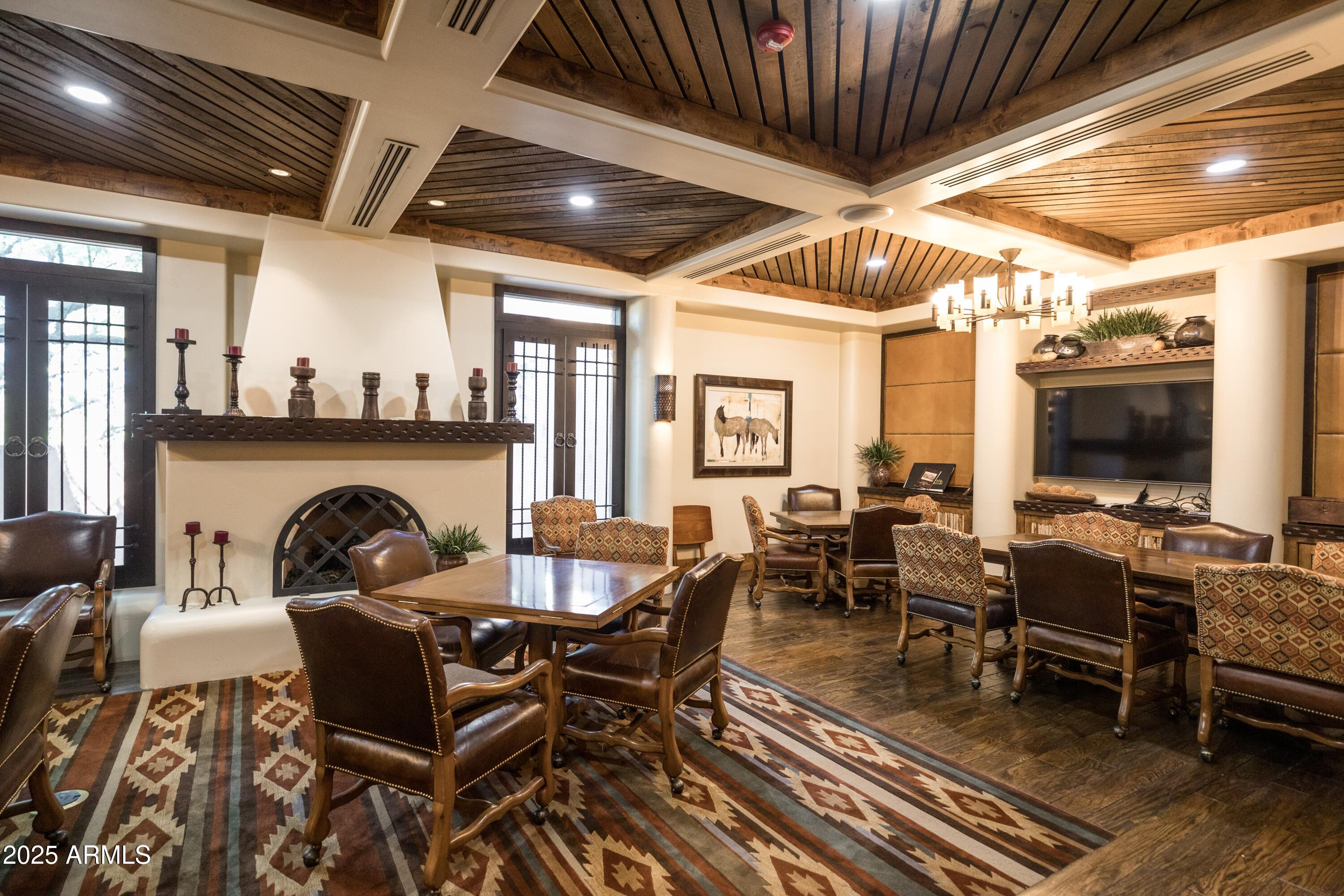 18788 East Blue Sky Drive Rio Verde, AZ 85263 - Photo 49 of 80 a dining room with furniture a fireplace and wooden floor
