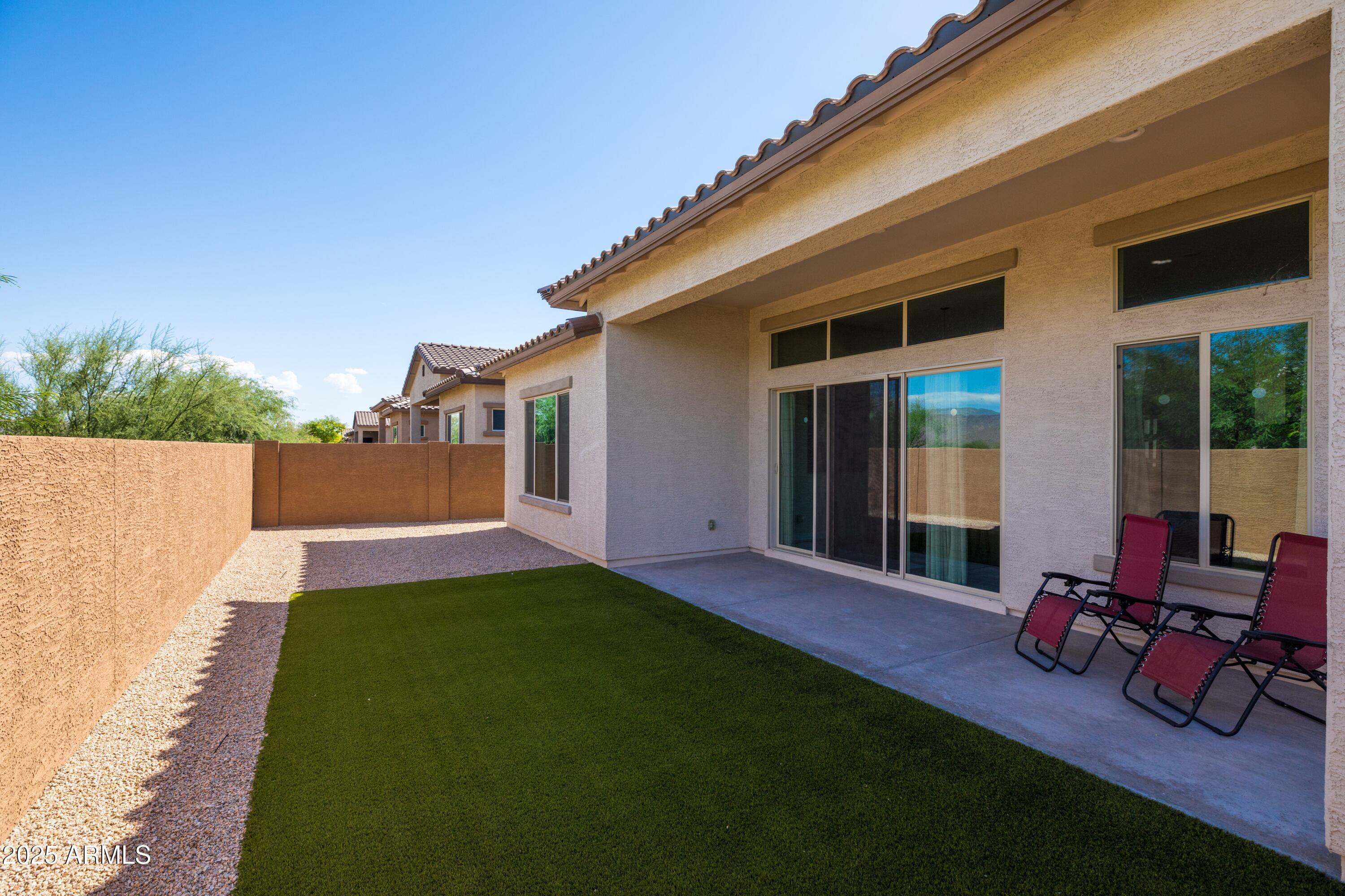 18788 East Blue Sky Drive Rio Verde, AZ 85263 - Photo 6 of 80 a view of a backyard with couches plants and large tree