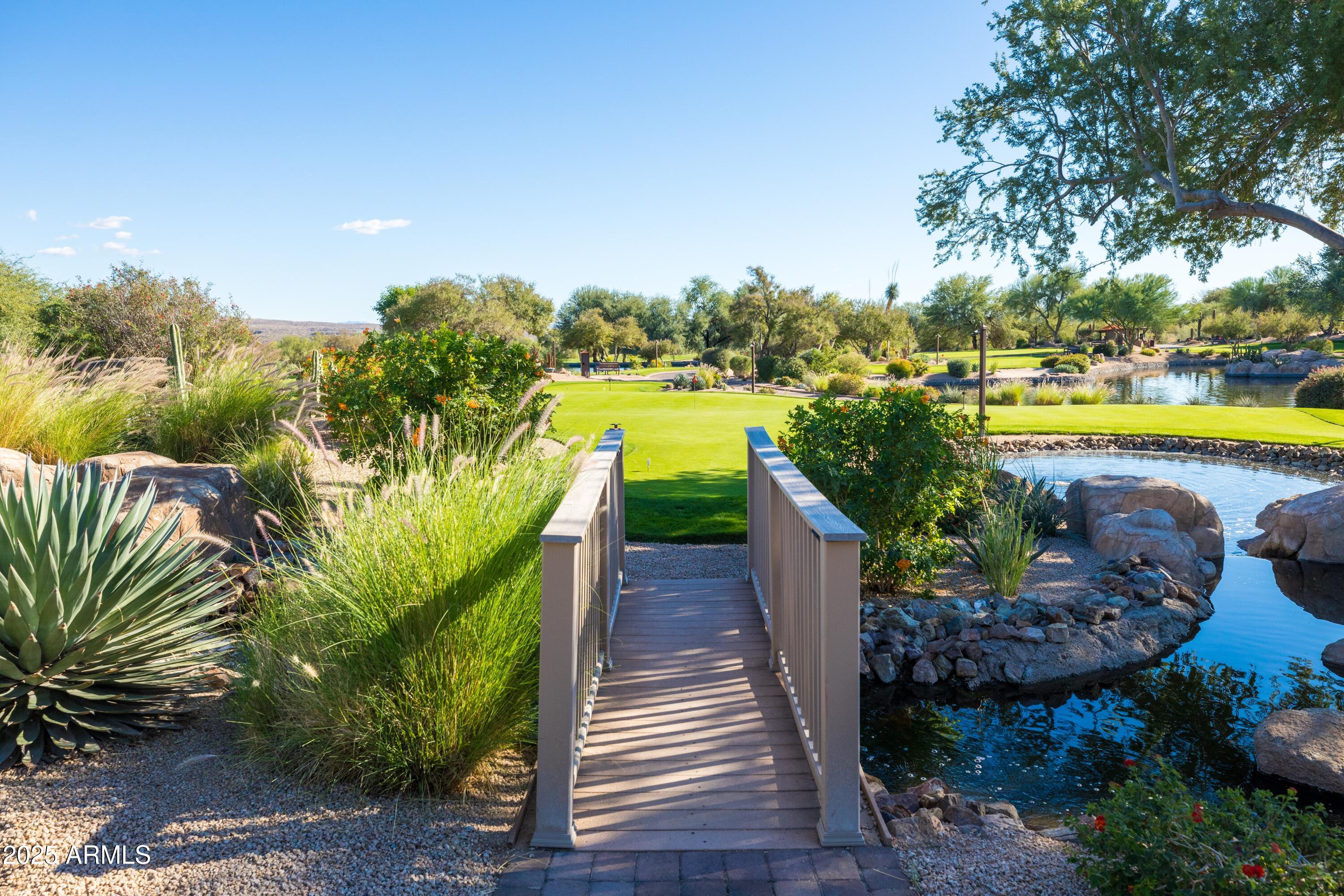 18788 East Blue Sky Drive Rio Verde, AZ 85263 - Photo 67 of 80 a view of a swimming pool with a garden and outdoor seating
