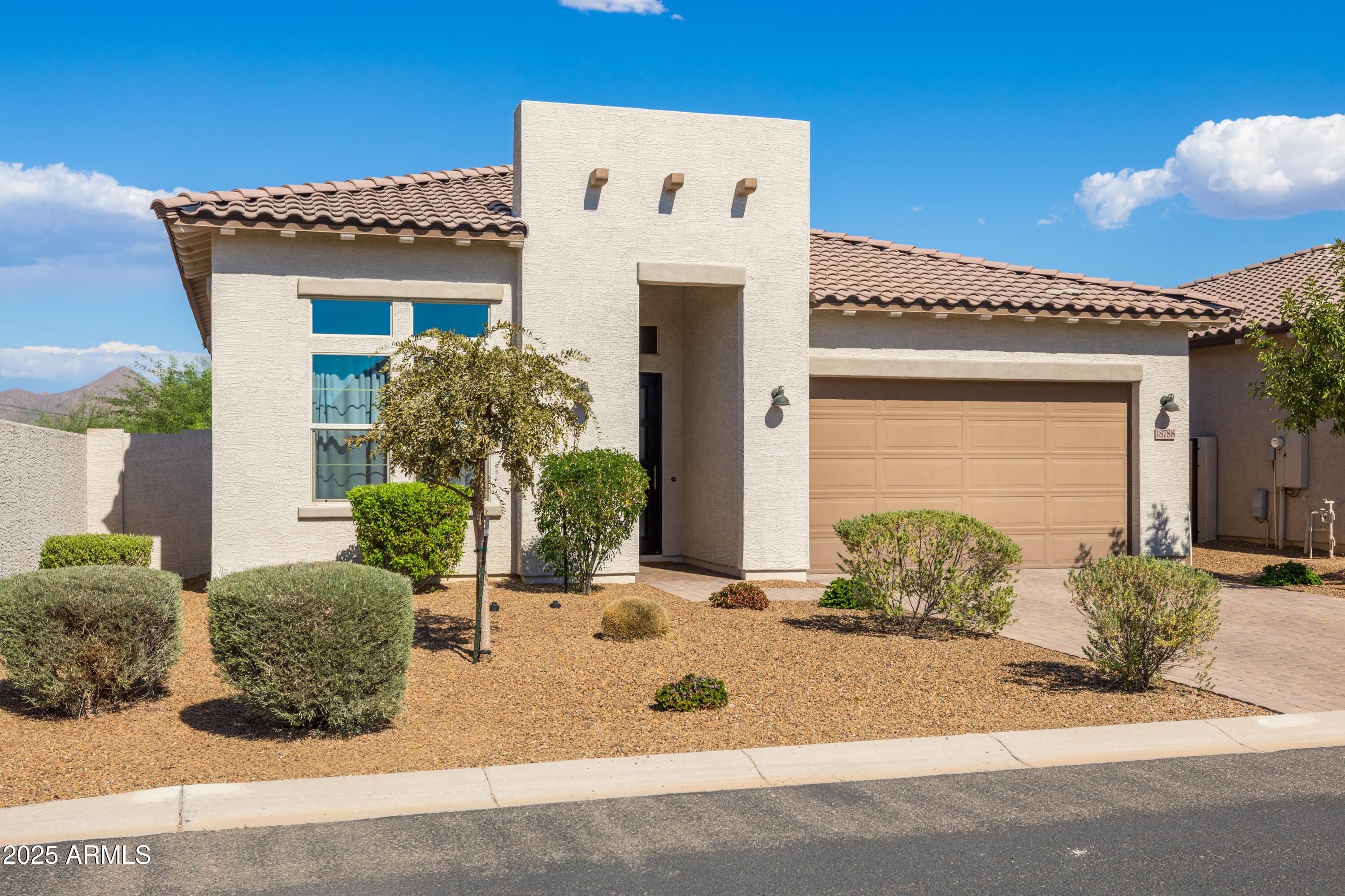 18788 East Blue Sky Drive Rio Verde, AZ 85263 - Photo 7 of 80 a front view of a house with garden