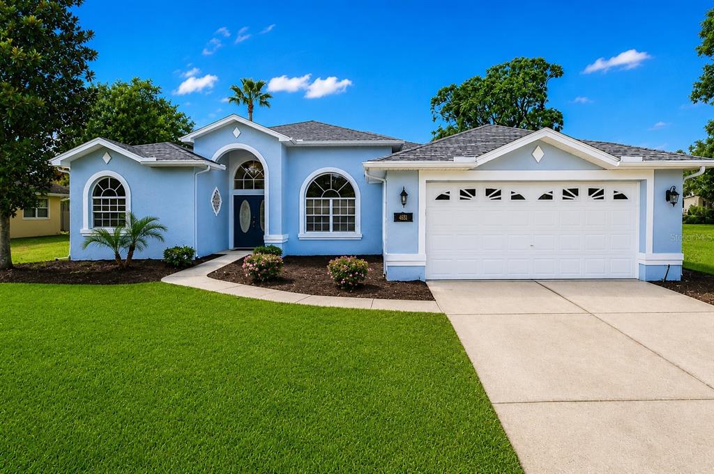 14178 Pullman Drive Spring Hill, FL 34609 - Photo 1 of 46 a view of a house with a yard and a garden