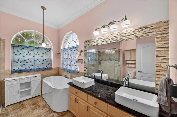 a spacious bathroom with a granite countertop sink mirror vanity and toilet