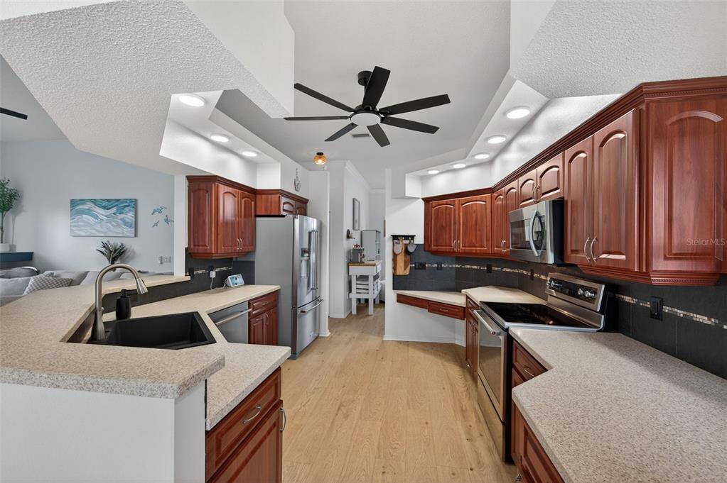14178 Pullman Drive Spring Hill, FL 34609 - Photo 15 of 46 a kitchen that has a sink a counter space and stainless steel appliances