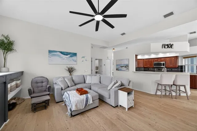 a view of a swimming pool with a yard and lawn chairs