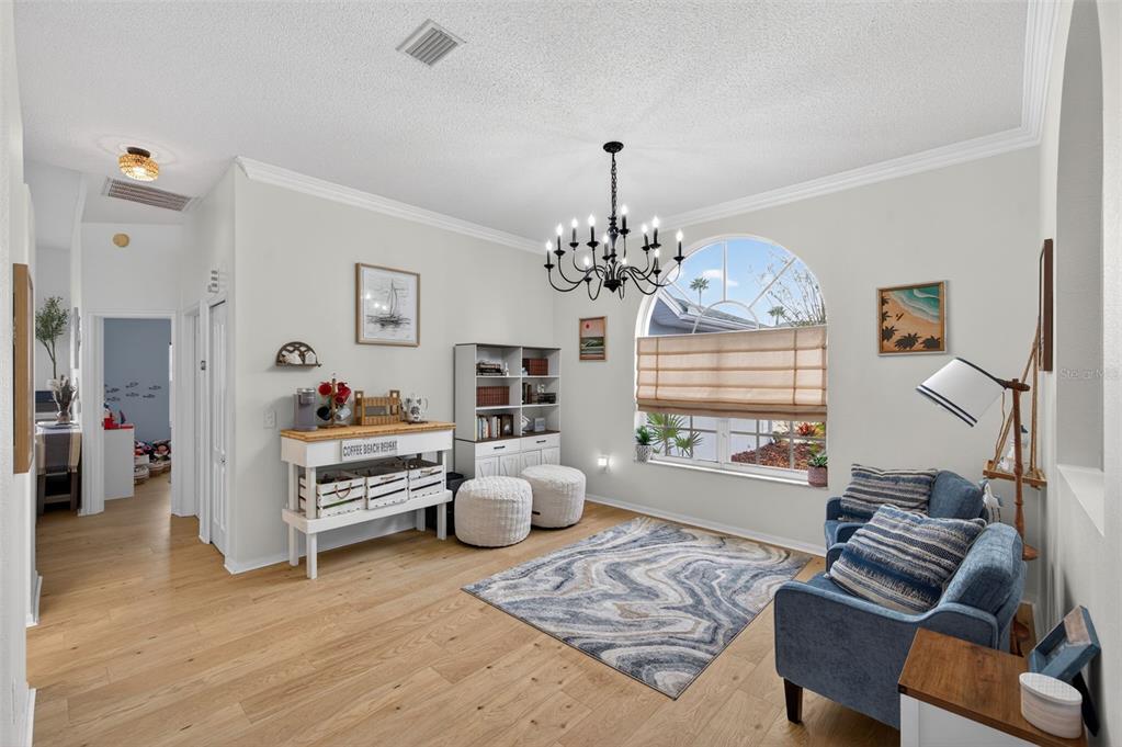 14178 Pullman Drive Spring Hill, FL 34609 - Photo 8 of 46 a living room with furniture and a chandelier