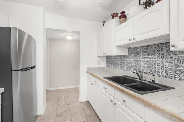 a kitchen with a sink and refrigerator