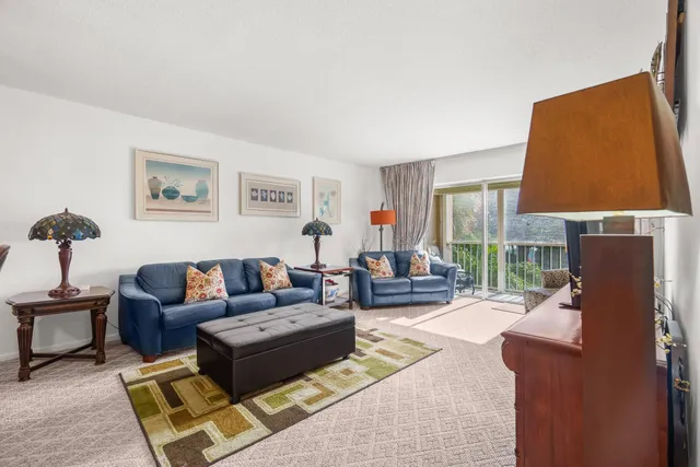 a living room with furniture a large window and a flat screen tv