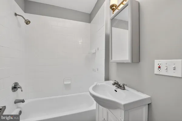 a bathroom with a sink a mirror and a bathtub