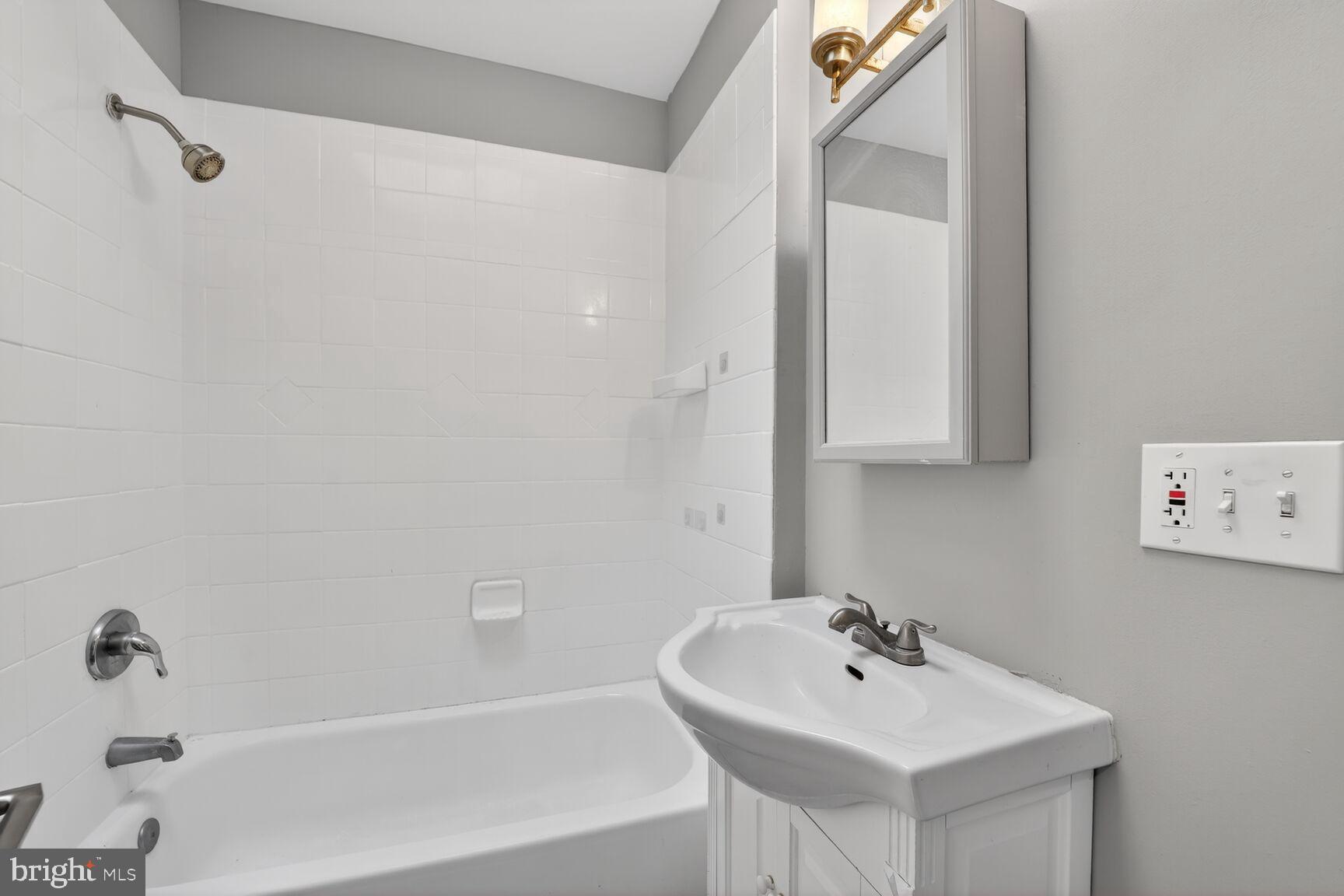 632 Franklin Street Northeast Washington, DC 20017 - Photo 11 of 19 a bathroom with a sink a mirror and a bathtub