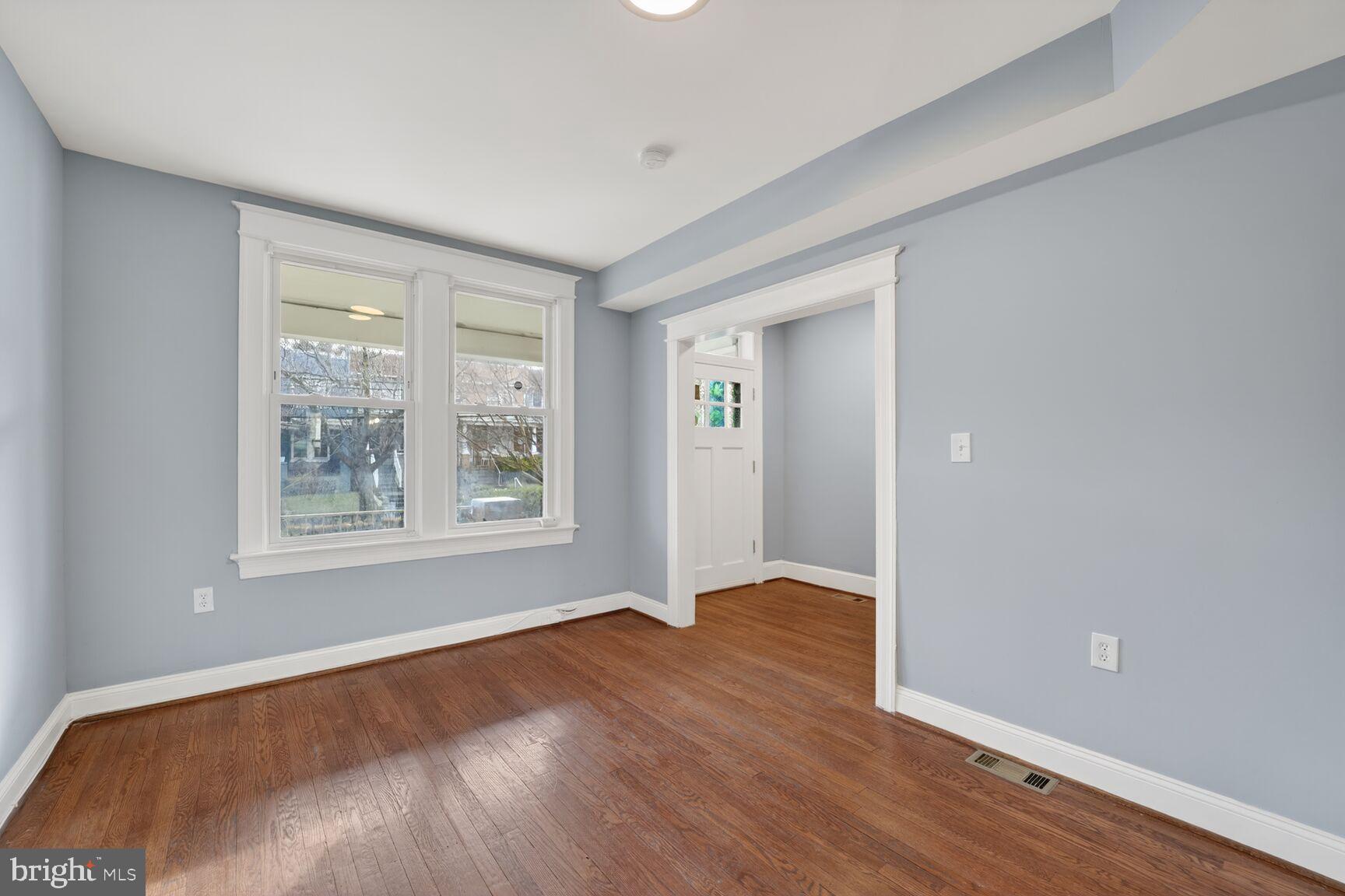 632 Franklin Street Northeast Washington, DC 20017 - Photo 4 of 19 a view of an empty room with wooden floor and a window