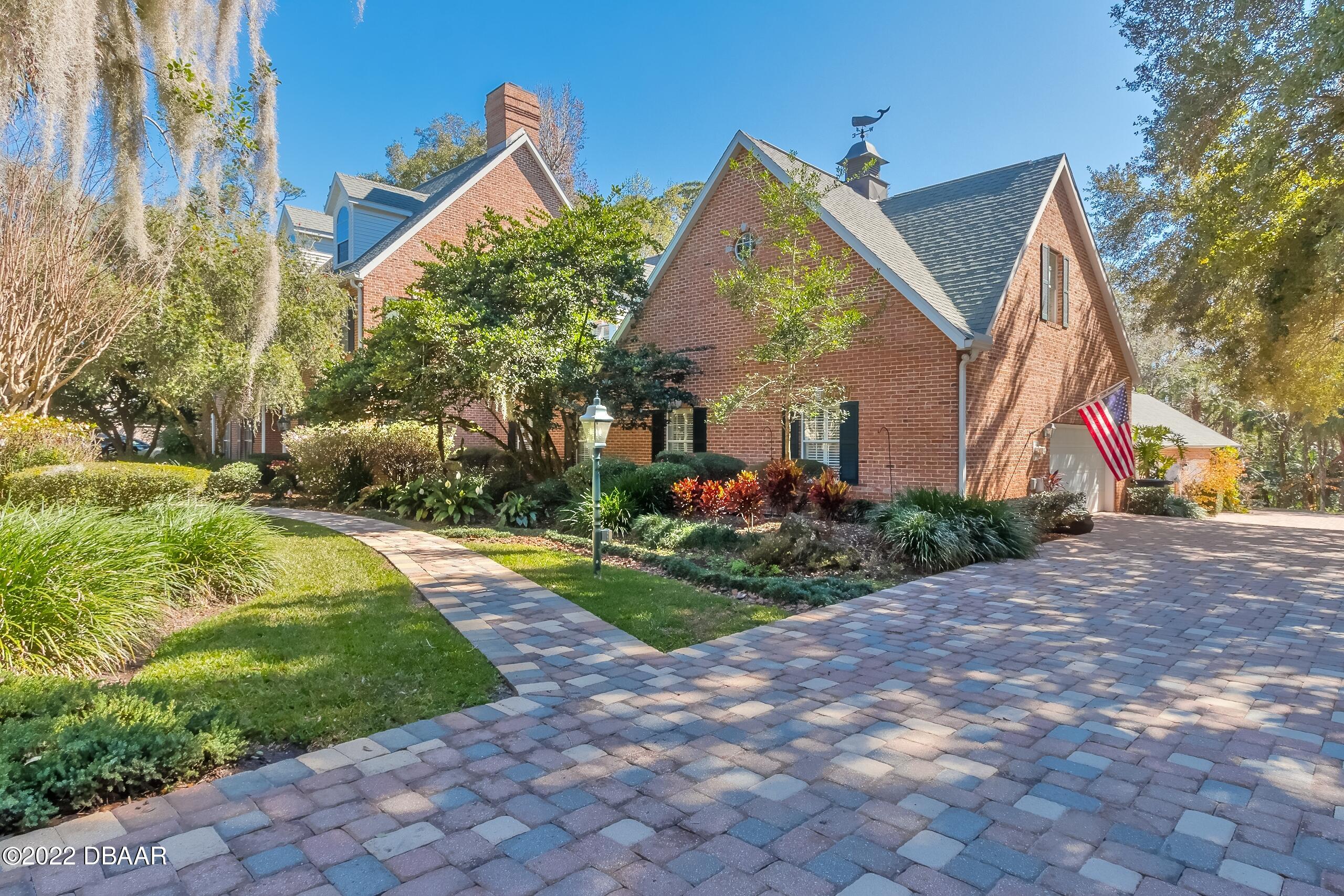 8 Moss Point Drive Ormond Beach, FL 32174 - Photo 2 of 63 a view of a house with a yard and plants