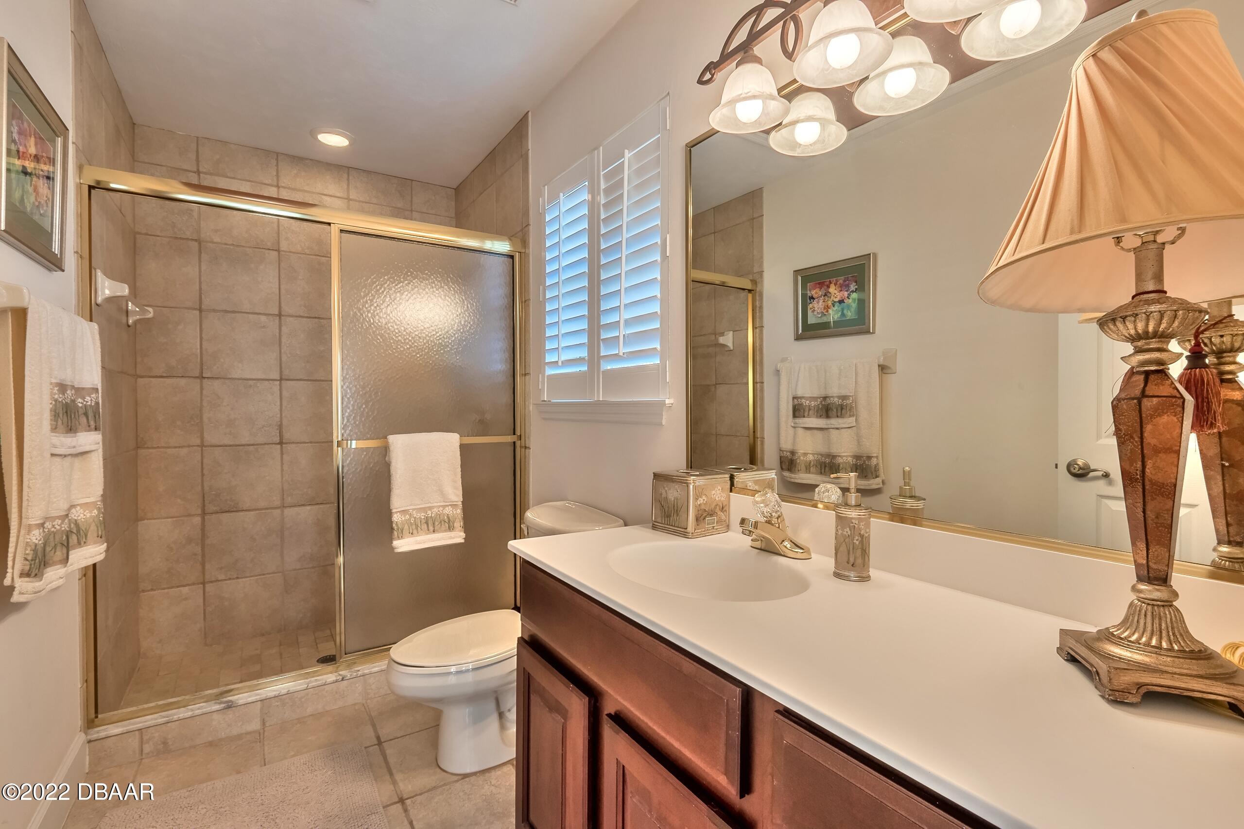 8 Moss Point Drive Ormond Beach, FL 32174 - Photo 22 of 63 a bathroom with a sink a toilet and shower