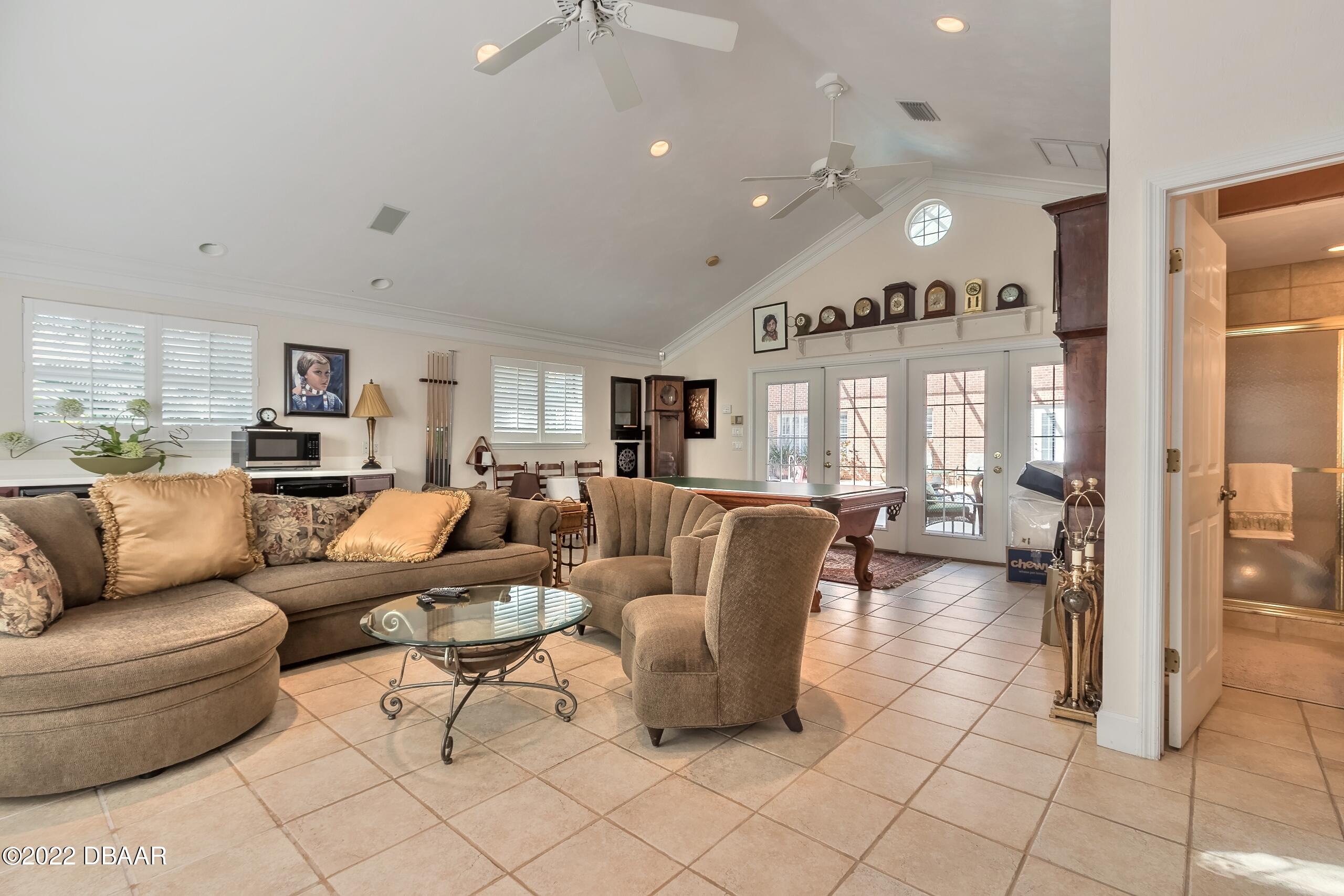 8 Moss Point Drive Ormond Beach, FL 32174 - Photo 23 of 63 a living room with furniture and a large window