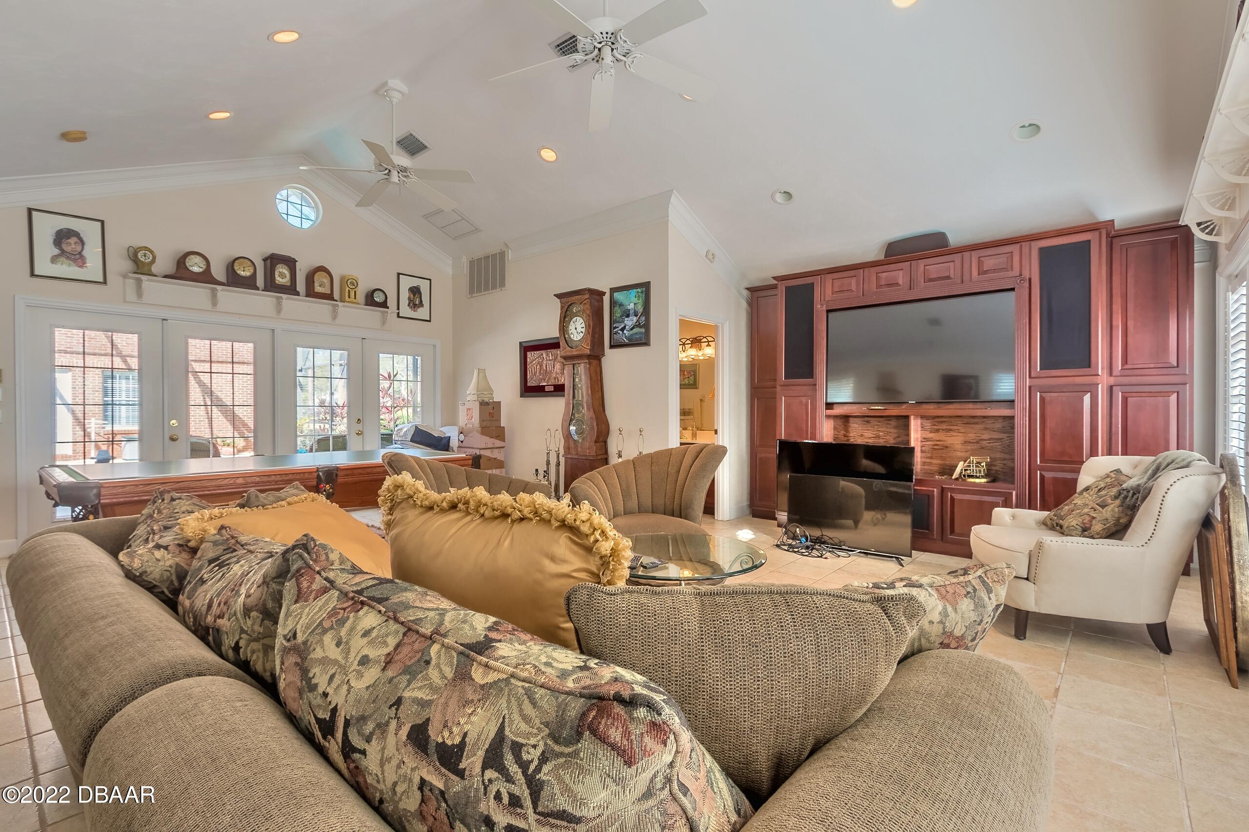 8 Moss Point Drive Ormond Beach, FL 32174 - Photo 24 of 63 a living room with furniture and a flat screen tv