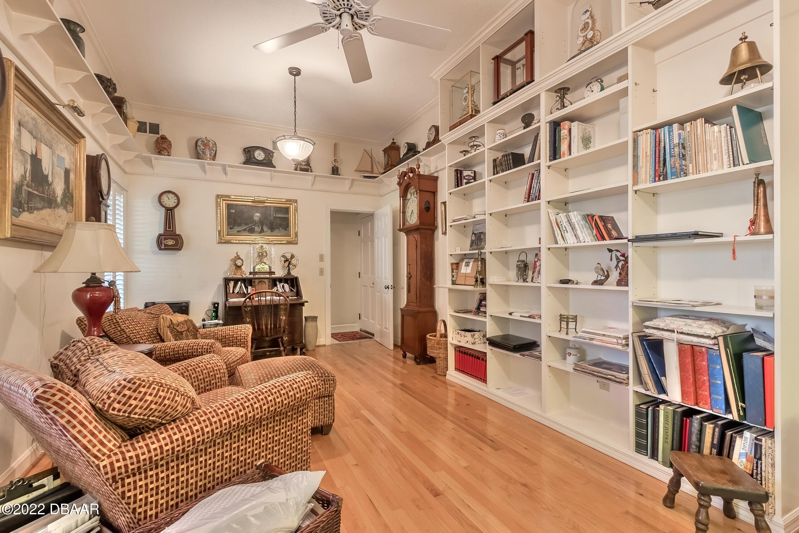 8 Moss Point Drive Ormond Beach, FL 32174 - Photo 26 of 63 a living room with furniture and a book shelf